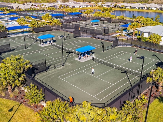 view of sport court featuring a water view