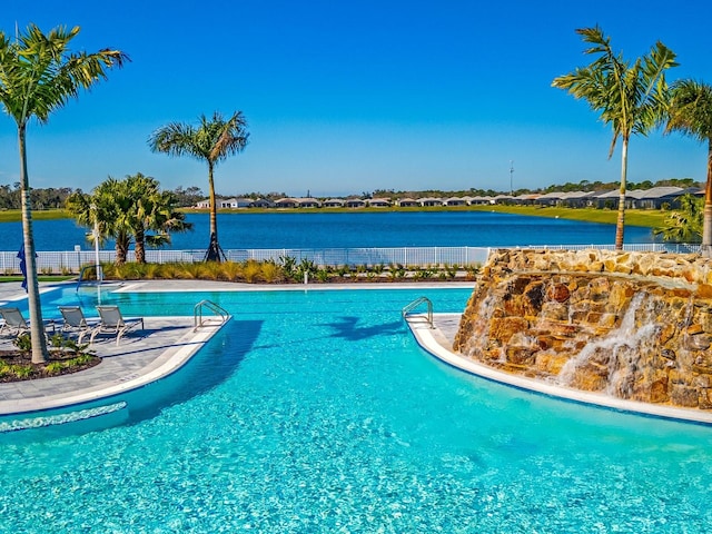 view of swimming pool featuring a water view