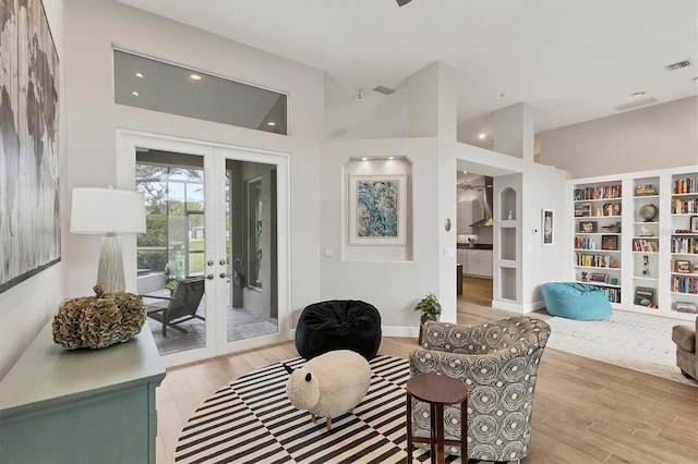 sitting room featuring light hardwood / wood-style floors and french doors