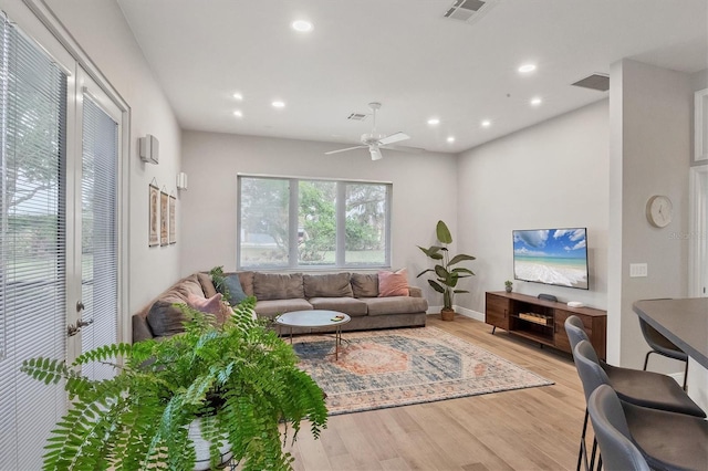 living room with ceiling fan and light wood-type flooring