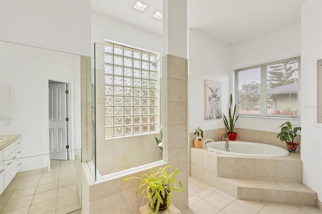 bathroom with vanity, tile patterned flooring, and plus walk in shower