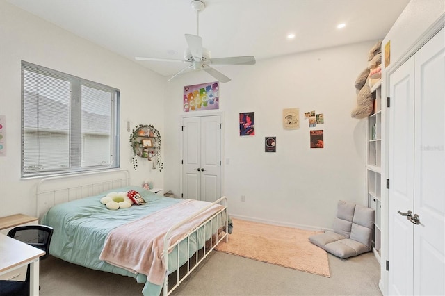 carpeted bedroom featuring ceiling fan and a closet