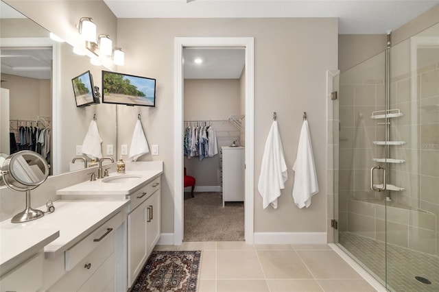 bathroom featuring vanity, tile patterned floors, and a shower with shower door