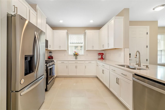 16127 Fortezza Dr, Bradenton, FL 34211 - kitchen with appliances with stainless steel finishes, backsplash, white cabinets, and recessed lighting