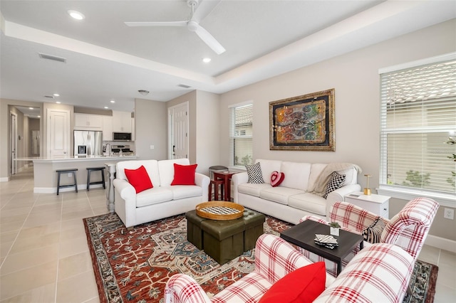 16127 Fortezza Dr, Bradenton, FL 34211 - living area with a ceiling fan, recessed lighting, light tile patterned floors, and a tray ceiling