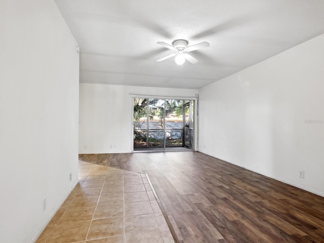 empty room featuring ceiling fan and light hardwood / wood-style flooring