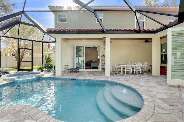 back of house with ceiling fan, a lanai, a patio, and a swimming pool with hot tub