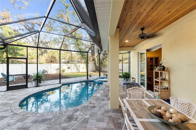 view of swimming pool with a lanai, an in ground hot tub, and a patio area