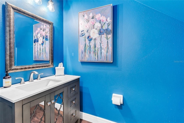 bathroom with vanity and baseboards