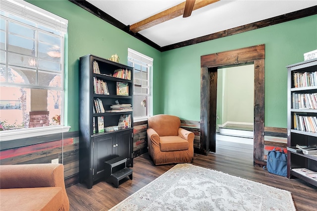 sitting room with beam ceiling and dark wood-type flooring