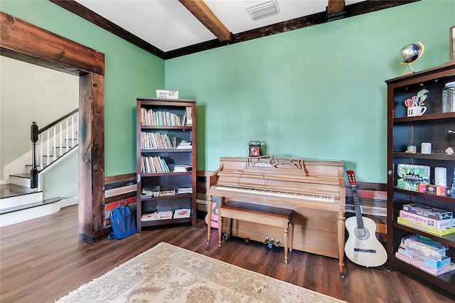 interior space featuring beam ceiling, visible vents, and wood finished floors