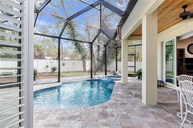 view of pool with a patio, a fenced backyard, a pool with connected hot tub, and a lanai