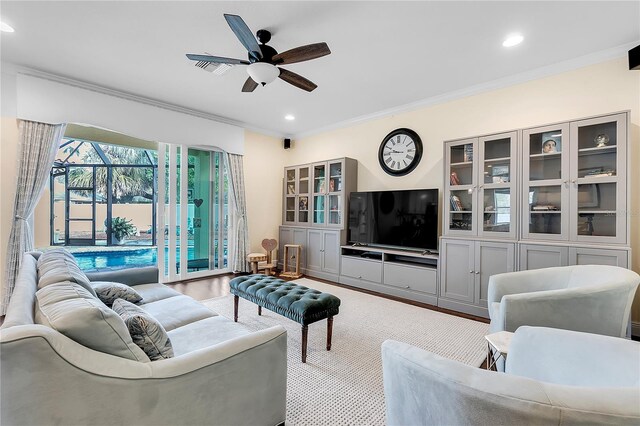 living room with a ceiling fan, crown molding, recessed lighting, and wood finished floors