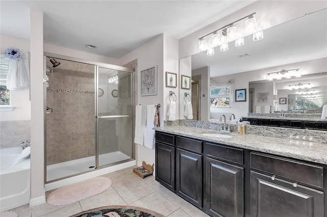 full bath featuring tile patterned flooring, a stall shower, a garden tub, and vanity