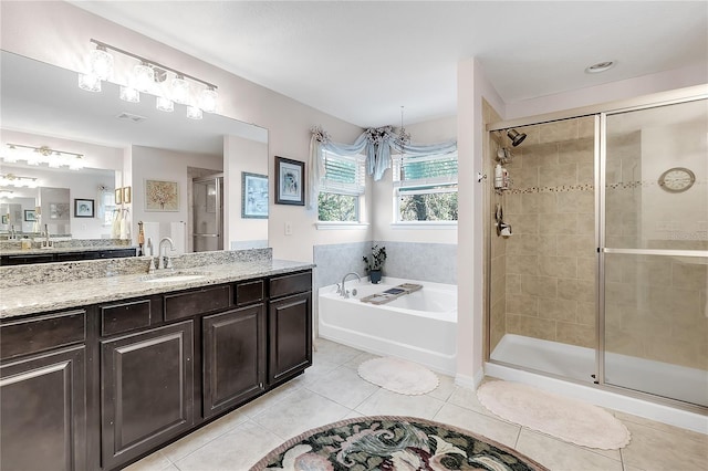 full bath with tile patterned floors, a stall shower, a garden tub, and vanity