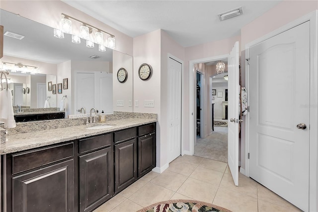 full bathroom with tile patterned flooring, vanity, and baseboards