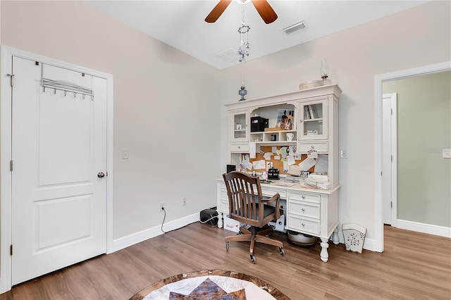 office area featuring wood finished floors, a ceiling fan, and baseboards
