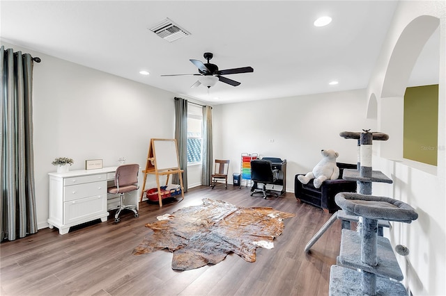 home office with arched walkways, wood finished floors, recessed lighting, ceiling fan, and baseboards