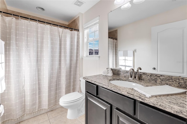 bathroom featuring tile patterned flooring, toilet, vanity, and curtained shower