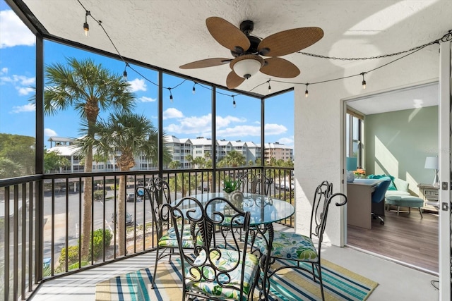 sunroom featuring ceiling fan