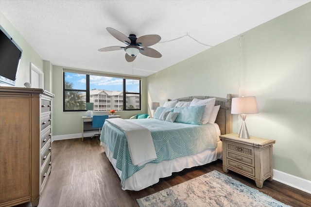 bedroom featuring ceiling fan, dark hardwood / wood-style floors, and a textured ceiling