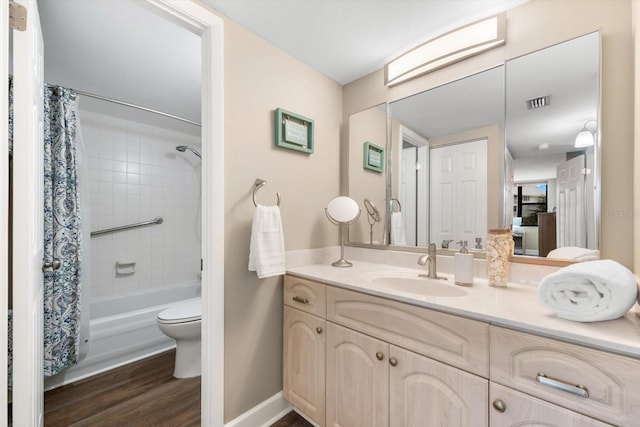 full bathroom with toilet, vanity, shower / tub combo with curtain, and hardwood / wood-style floors