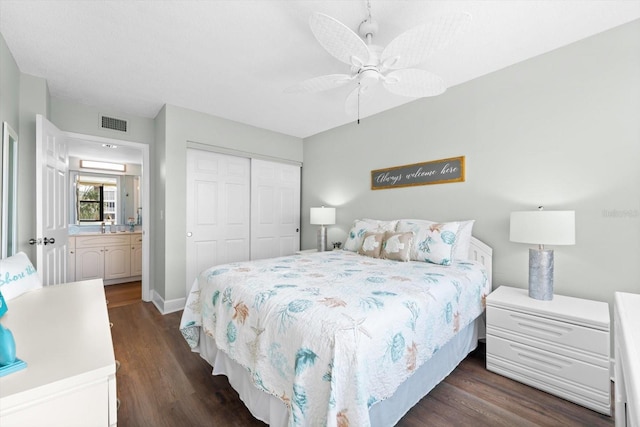 bedroom featuring ceiling fan, ensuite bathroom, a closet, and dark hardwood / wood-style flooring