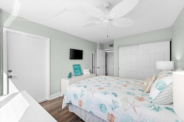 bedroom with ceiling fan, a closet, and dark hardwood / wood-style floors