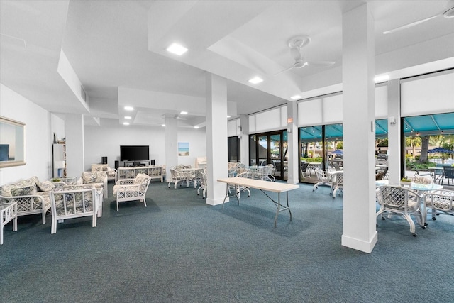 interior space featuring ceiling fan and carpet