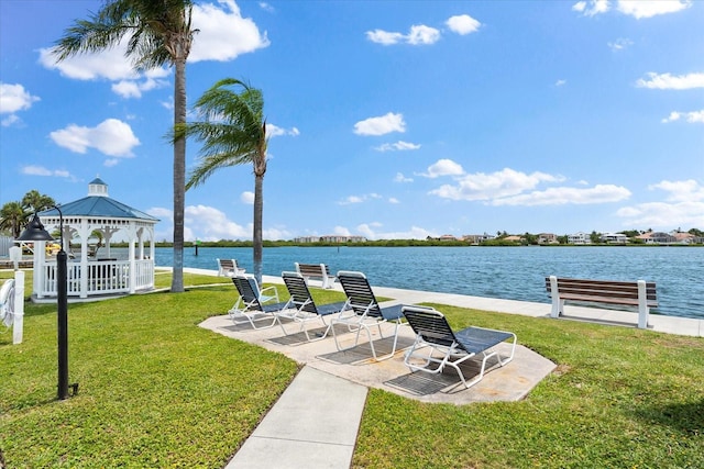 view of yard featuring a gazebo, a water view, and a patio