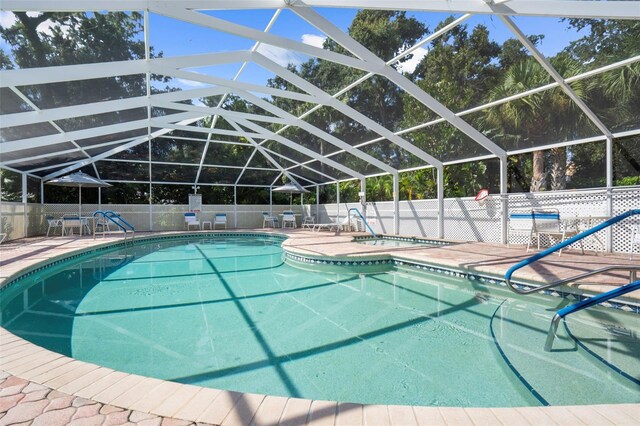 view of swimming pool featuring a lanai and a patio area