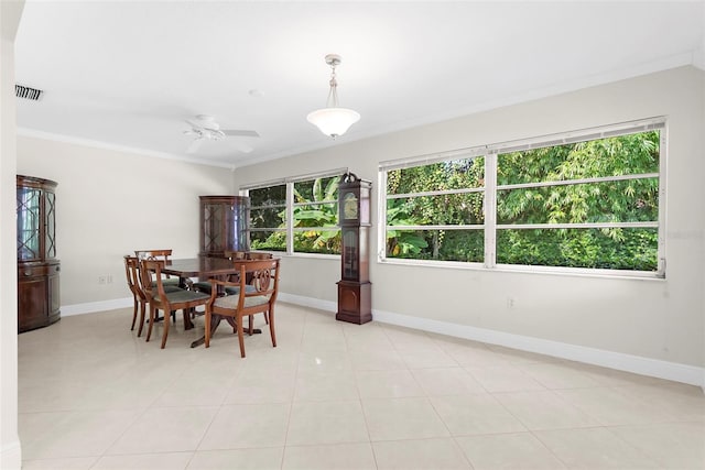 dining room with ceiling fan, a healthy amount of sunlight, light tile patterned floors, and crown molding