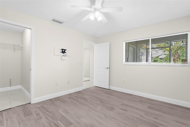 unfurnished bedroom with ceiling fan, a closet, and light hardwood / wood-style flooring