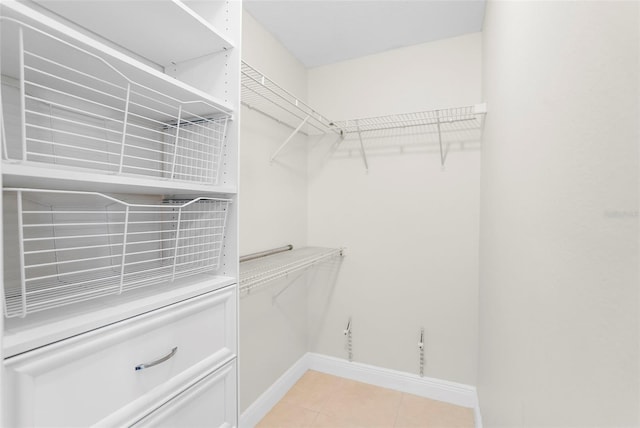 spacious closet with light tile patterned flooring