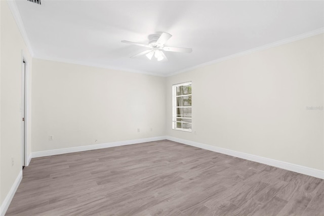 unfurnished room featuring light hardwood / wood-style floors, crown molding, and ceiling fan