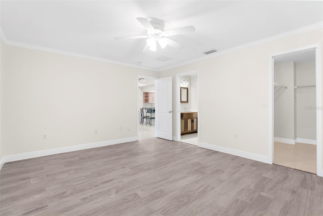 unfurnished living room featuring ceiling fan, ornamental molding, and light hardwood / wood-style floors