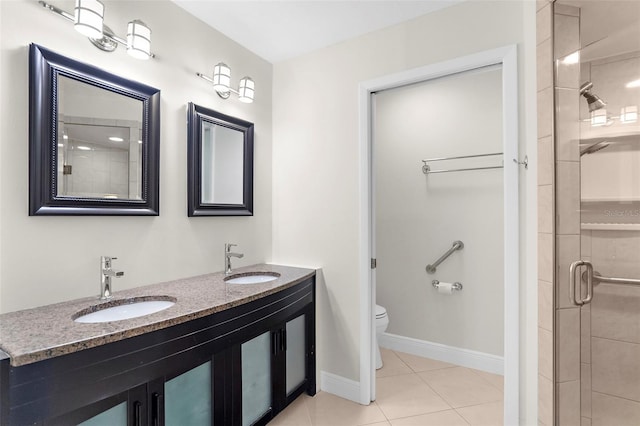 bathroom featuring toilet, tile patterned flooring, walk in shower, and vanity