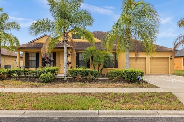 single story home featuring a garage and central AC unit