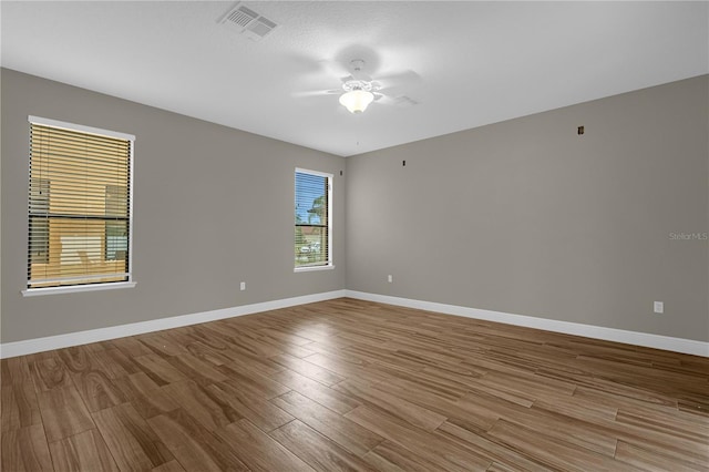 unfurnished room featuring hardwood / wood-style flooring and ceiling fan