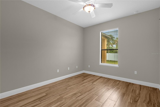 spare room featuring light hardwood / wood-style flooring and ceiling fan