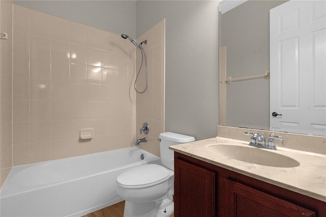 full bathroom with tiled shower / bath combo, vanity, and toilet