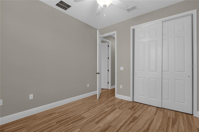 unfurnished bedroom with light hardwood / wood-style flooring, a closet, and ceiling fan