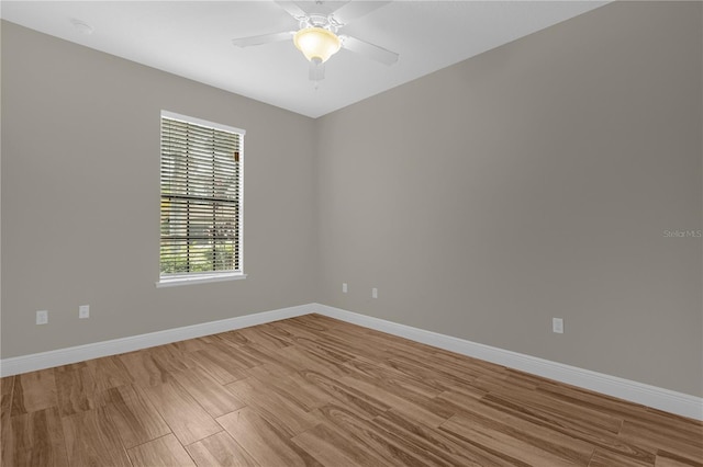 empty room with ceiling fan and light hardwood / wood-style floors