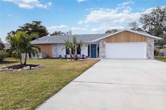 ranch-style house featuring a garage and a front lawn