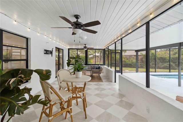 sunroom with ceiling fan and wood ceiling