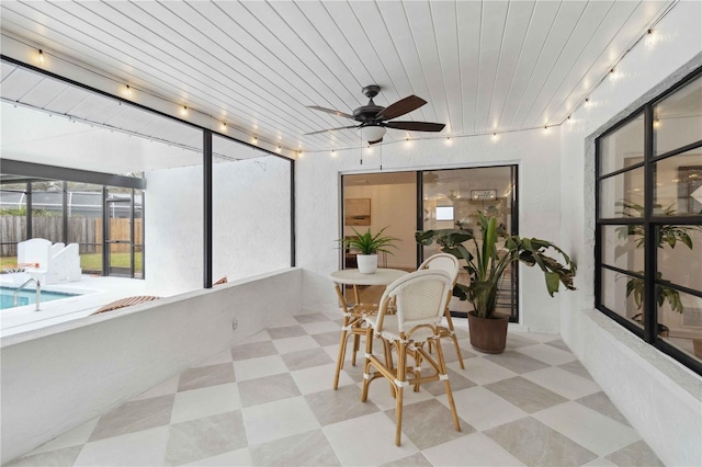 sunroom / solarium with ceiling fan and wood ceiling