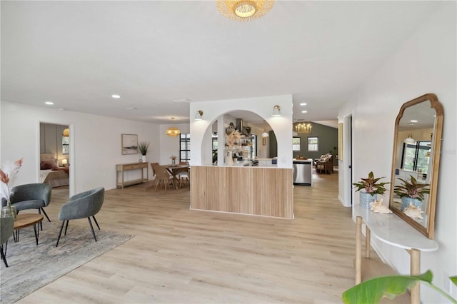 interior space featuring light brown cabinets, stainless steel dishwasher, and light wood-type flooring