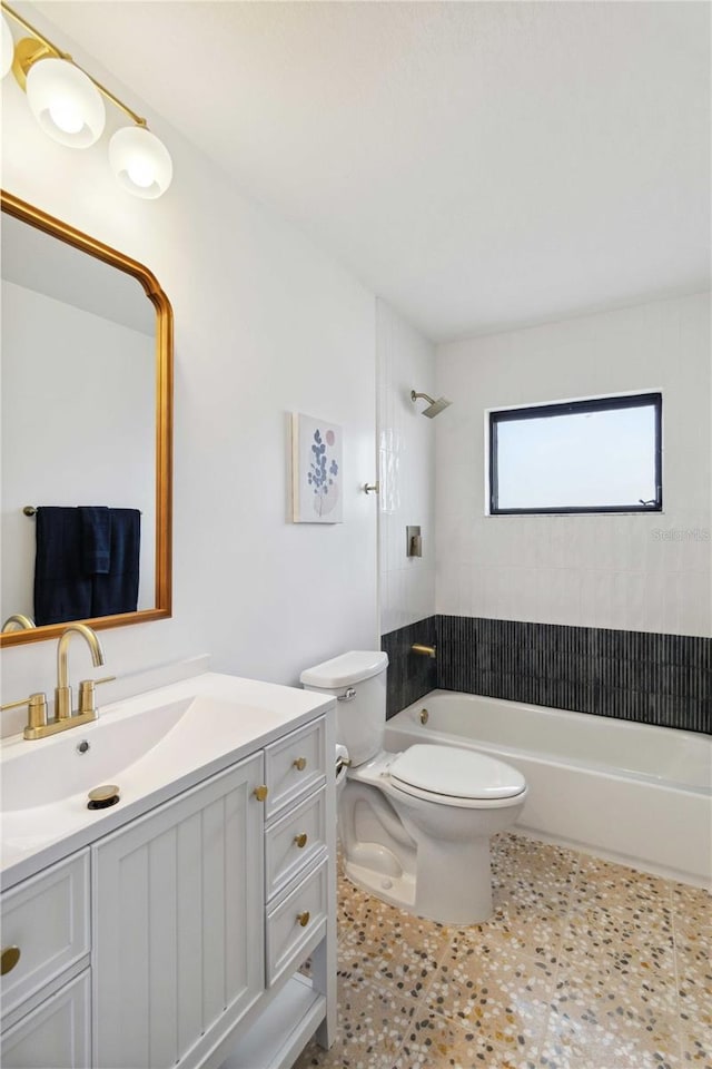 full bathroom featuring toilet, tile patterned flooring, tiled shower / bath, and vanity