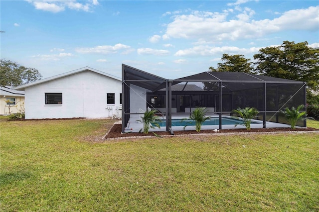 back of house featuring a lanai and a lawn