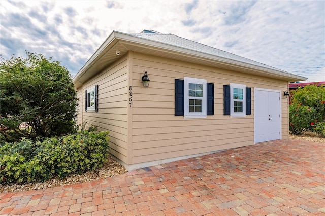 view of side of home with an outbuilding